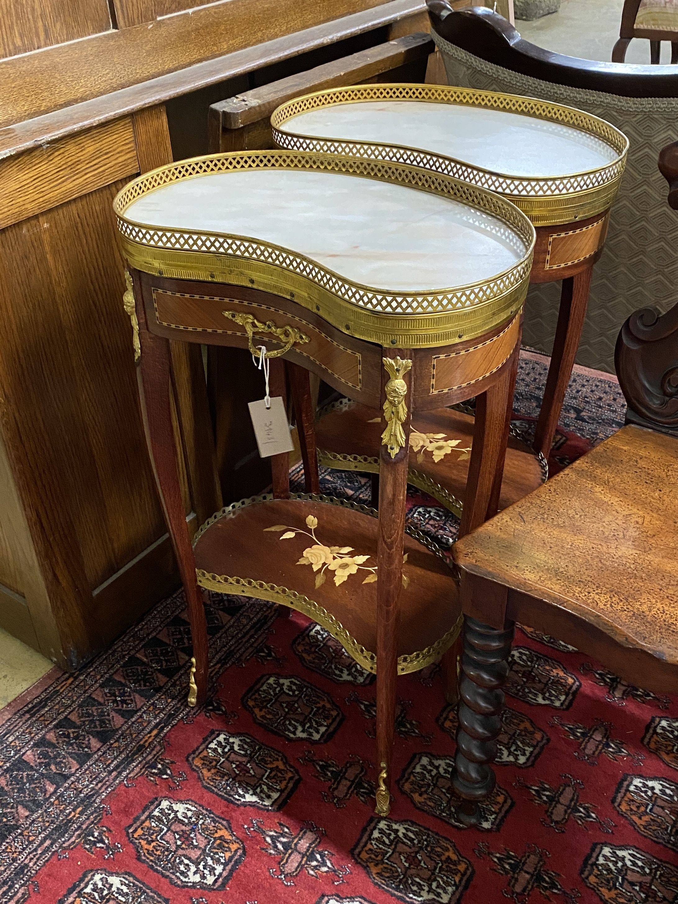 A pair of Louis XVI style marquetry inlaid marble topped kidney shaped bedside tables, width 44cm, depth 30cm, height 73cm